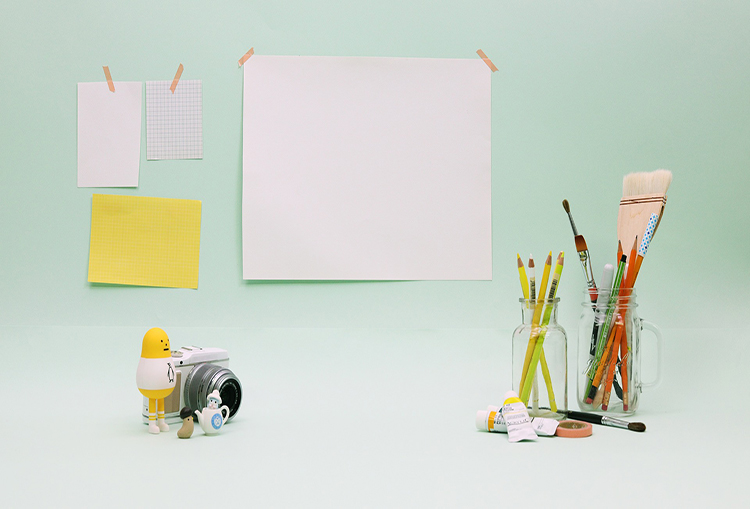 Desk with paper and paintbrushes 